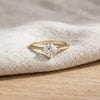 Asscher solitaire engagement ring resting on linen - Minted Jewellery