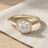 Claudia engagement ring resting on linen - Minted Jewellery