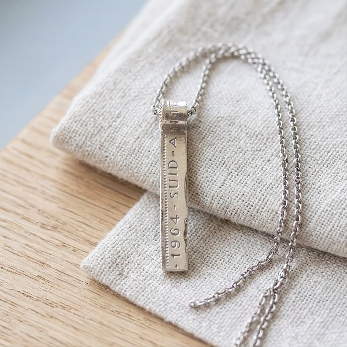 Vertical coin pendant necklace on linen - Minted Jewellery
