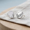 Silver coin stud earrings on linen - Minted Jewellery