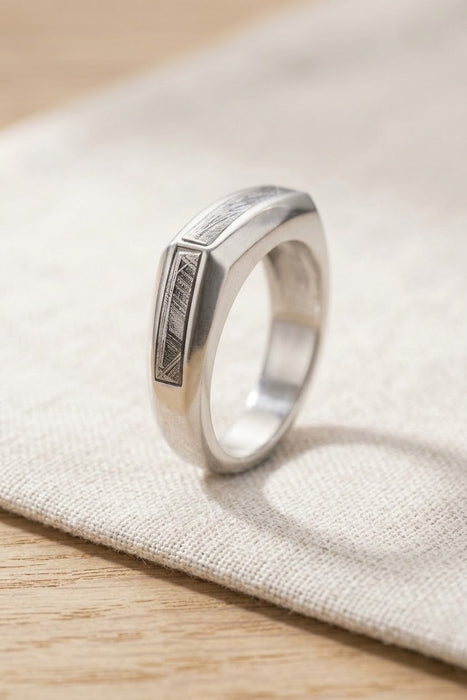 Mens silver meteorite ring resting on linen - Minted Jewellery
