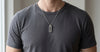 Muonionalusta meteorite tag necklace worn over a charcoal t-shirt - Minted Jewellery