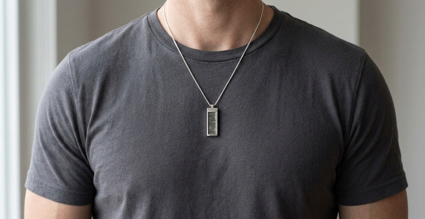 Muonionalusta meteorite tag necklace worn over a charcoal t-shirt - Minted Jewellery