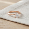 Oval moissanite solitaire ring resting on linen - Minted Jewellery