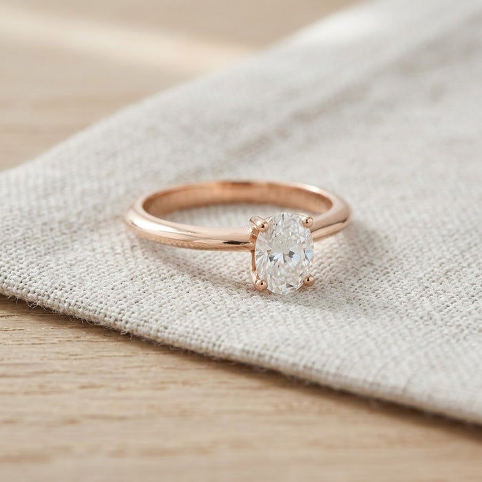 Oval moissanite solitaire ring resting on linen - Minted Jewellery