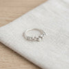 Silver grain ring resting on linen - Minted Jewellery