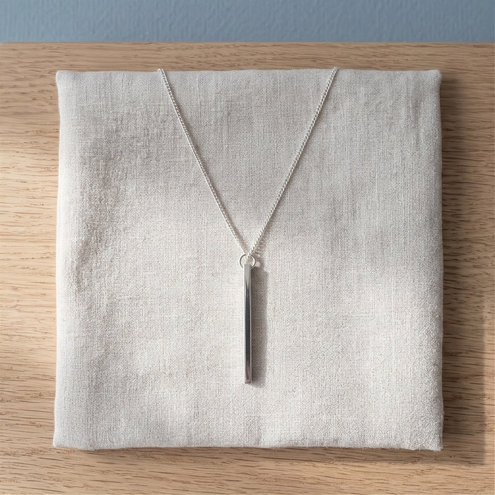 Vertical silver bar necklace on linen - Minted Jewellery